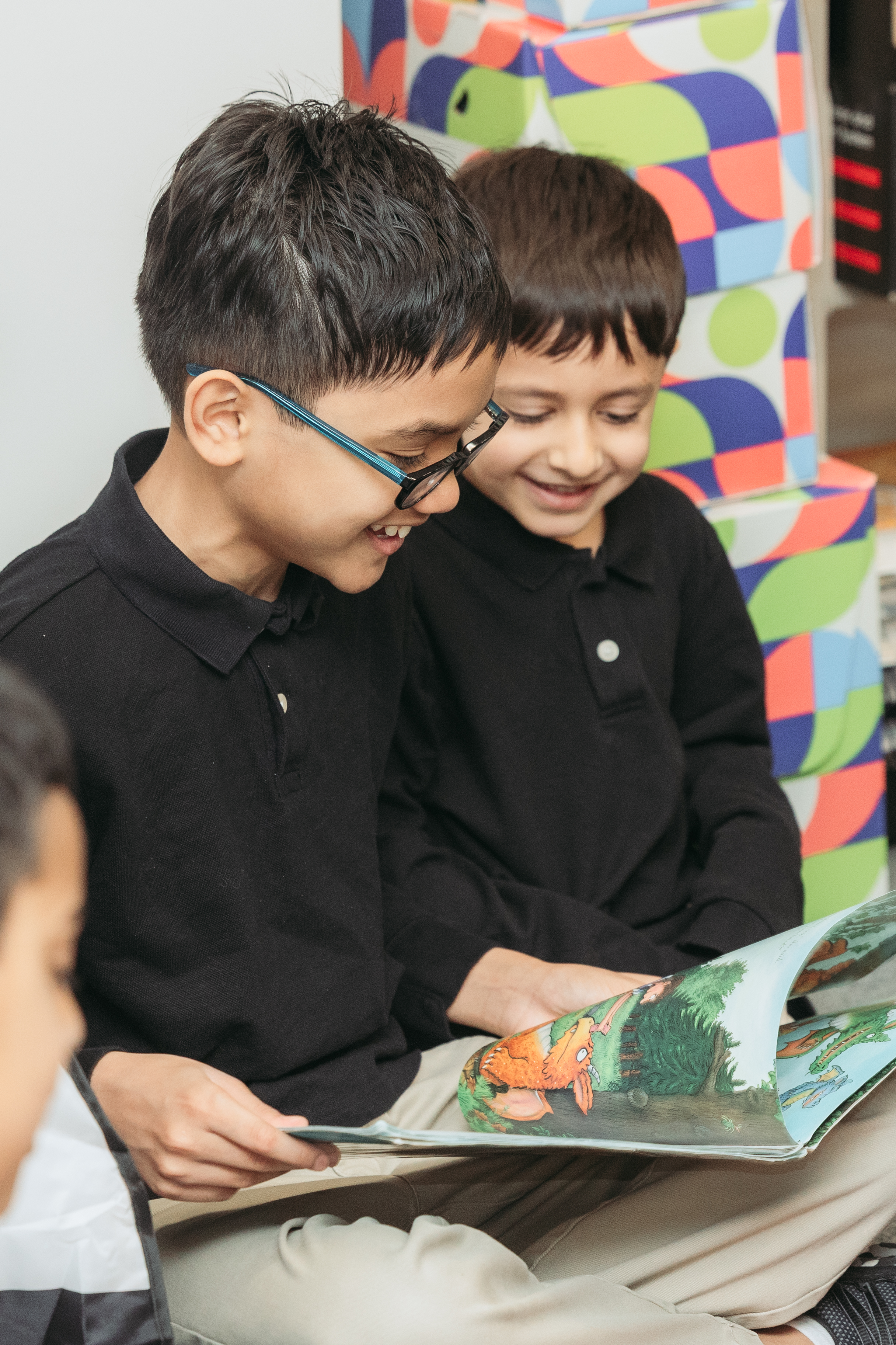 Two boys reading at the school library
