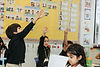 Students raising their hands in class