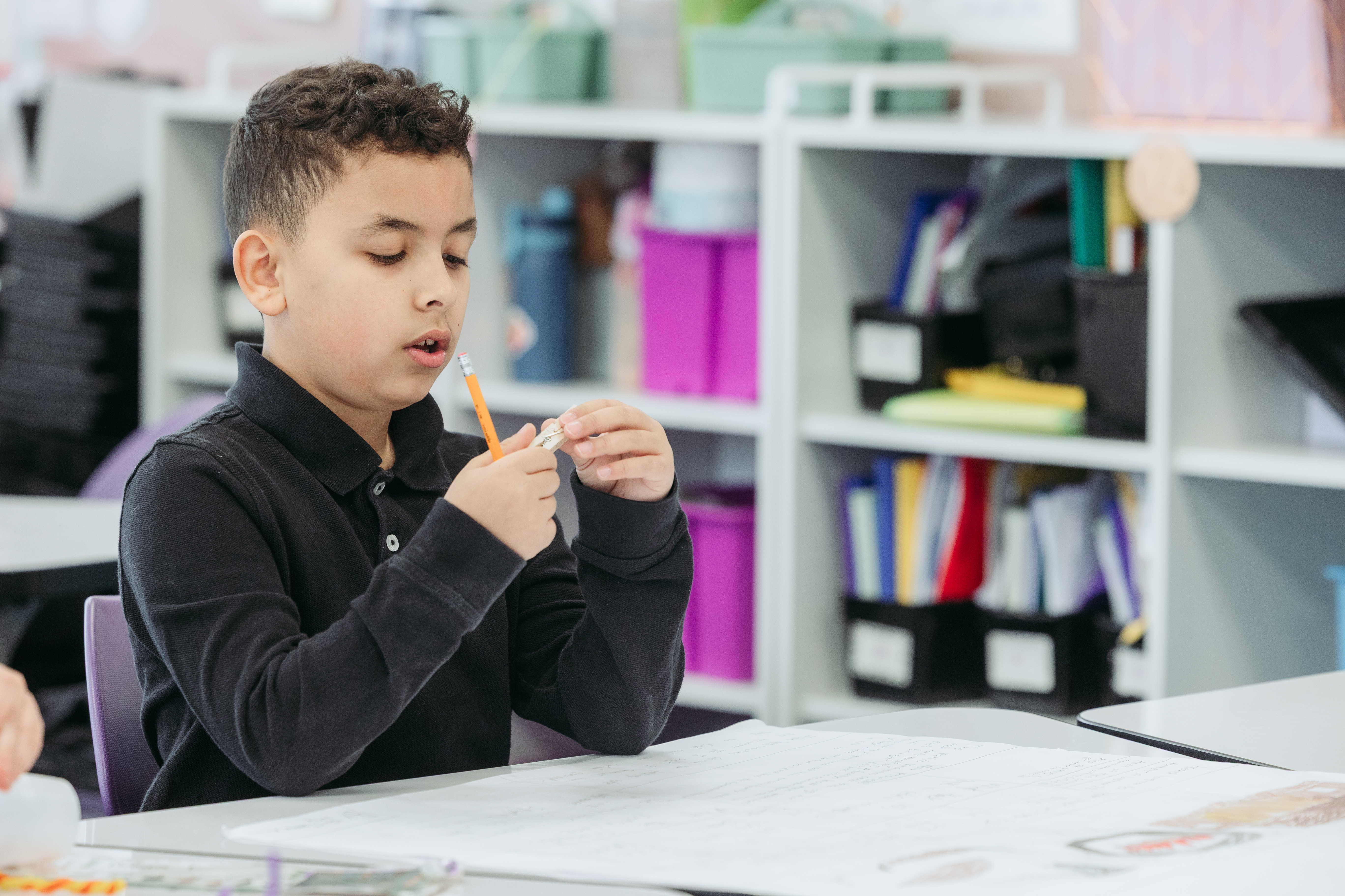 Sixth grader boy with pencil on hand