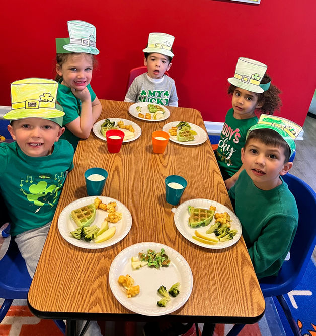 PreSchool kids having a healthy lunch on Fifi's Creative Kids Center and posing to the camera