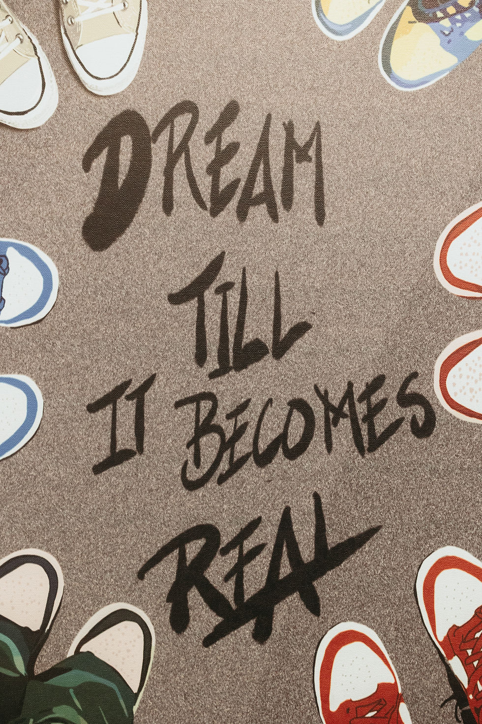 Poster that says "Dream till it becomes real"