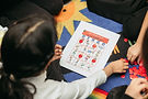 Girl playing bingo with Arabic words