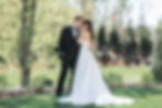 Bride and groom embracing outdoors