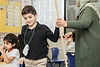Boy interacting with teacher in classroom