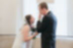 Groom wiping tears of joy as bride smiles