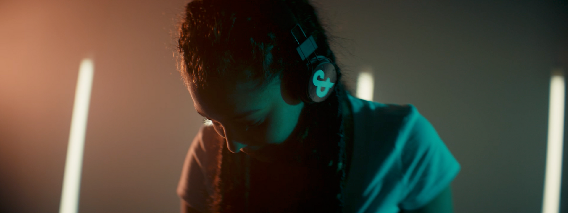 Closeup of a girl DJ wearing headphones