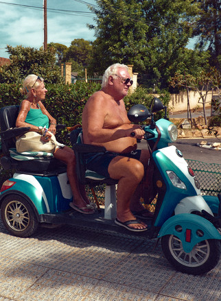 Retired couple riding on a scooter at Benidorm