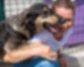 smiley-woman-playing-with-dog-up-adoption.jpg