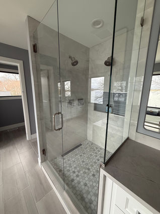 Frameless glass shower enclosure tile installation by MGC Remodeling