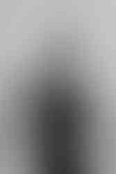 black and white photo of a long haired woman who points with the finger towards the camera