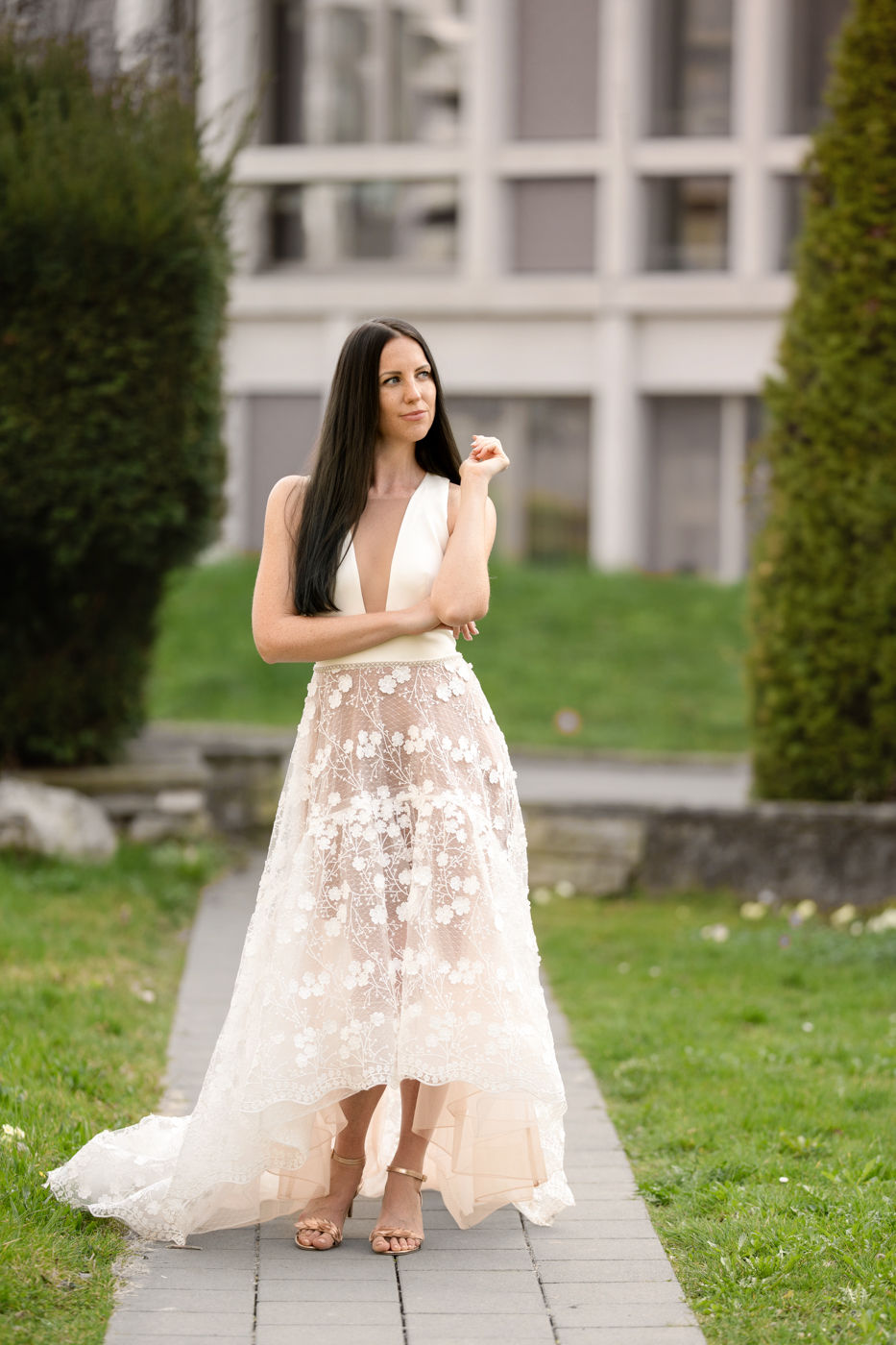 Thumbnail: High-low lace wedding dress with deep V neckline in Enso Brautkleider Zürich front full