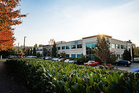 Exterior of office building with vehicles in parking lot