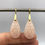 Thumbnail: Carved Peach Moonstone Drop Earrings in 18k Recycled Yellow Gold