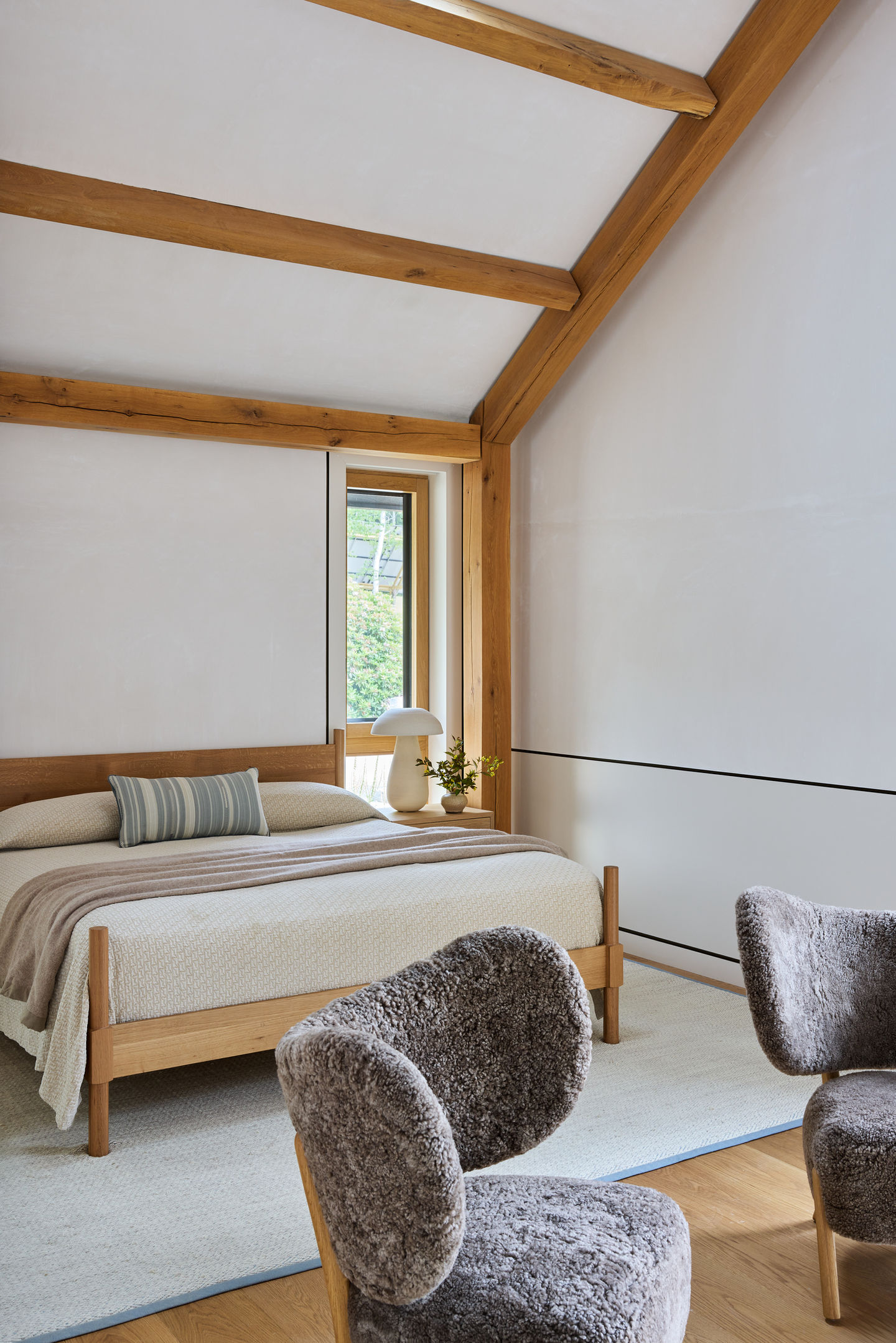 Warm yet minimal bedroom with rustic appeal.