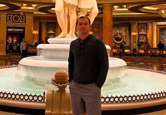 Man standing before a grand indoor fountain