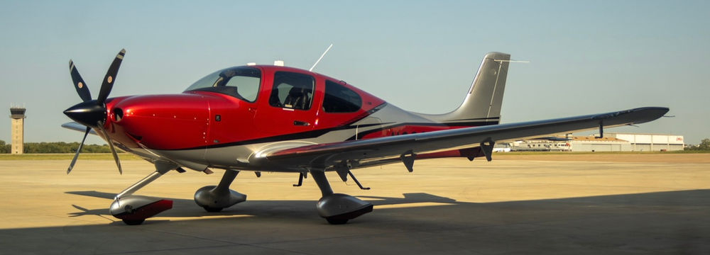 Red single-engine domestic aircraft on airfield