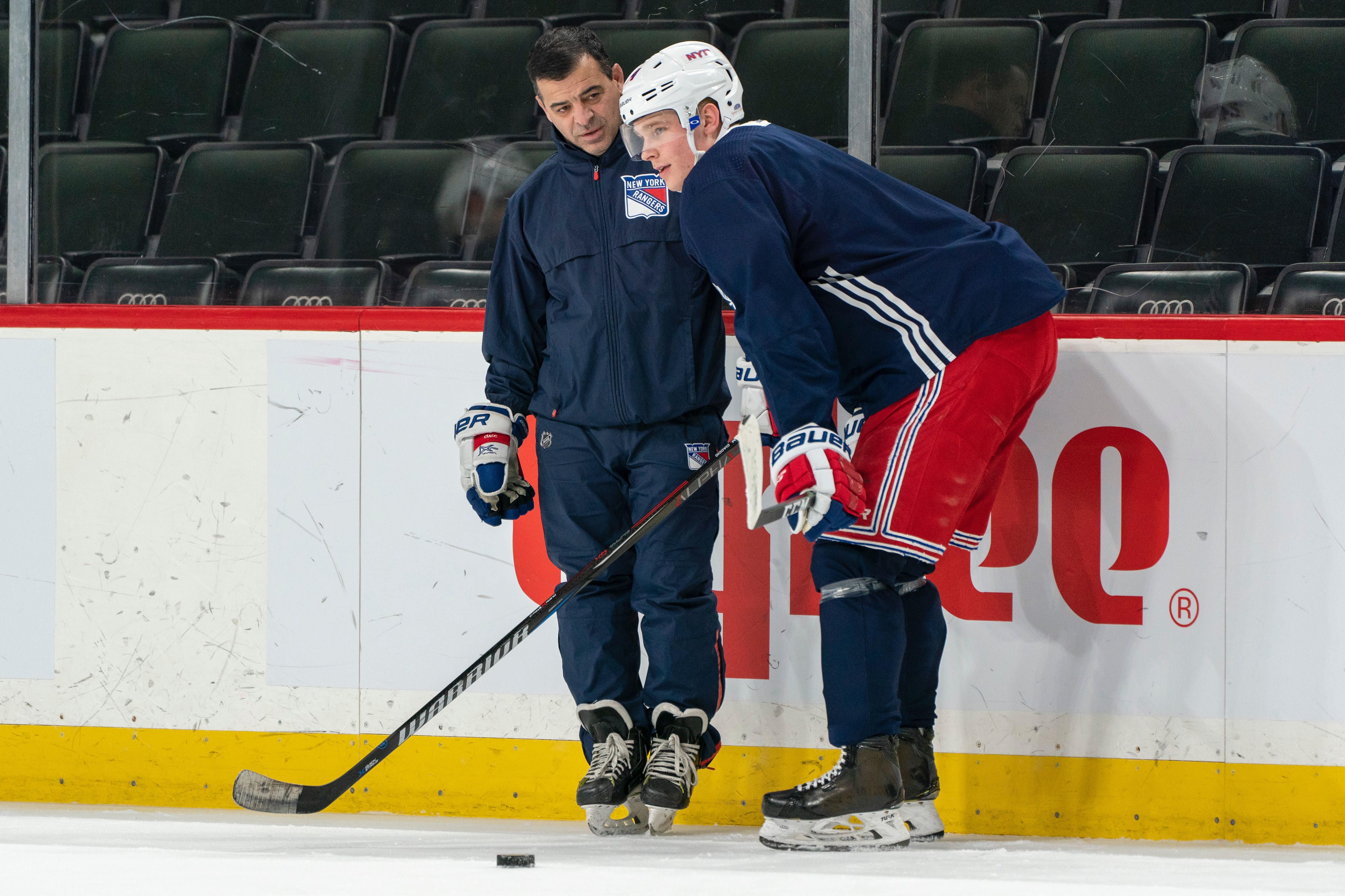Mark Ciaccio coaching a hockey player on the ice