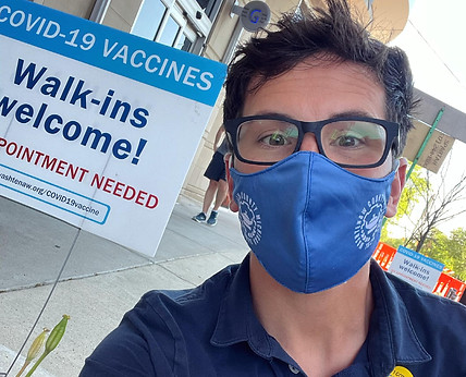 Rep. Morgan near a sign encouraging vaccinations