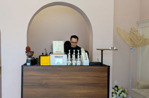 NOMADIKA barista behind custom-built walnut mobile espresso cart at a private event venue in Toronto