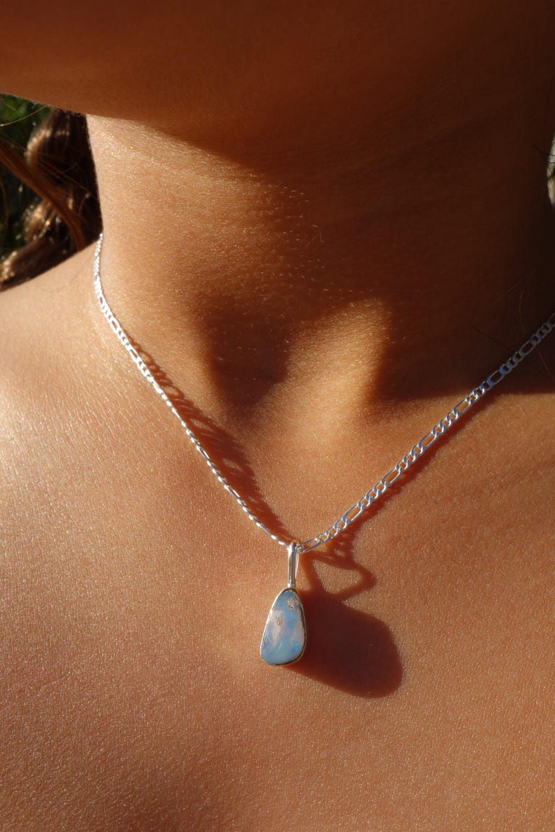 Boulder opal pendant worn on a sterling silver chain