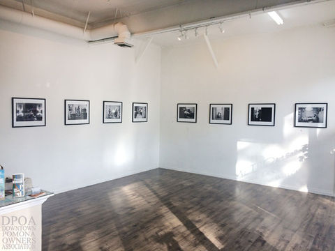 Gallery wall displaying black and white photos, in Downtown Pomona, California.
