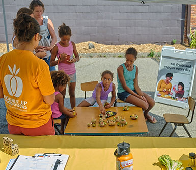 Kids at a table at the market
