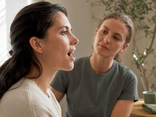 Patient assessing jaw movement with therapist