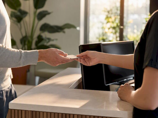 Patient hands giving insurance card at clinic reception