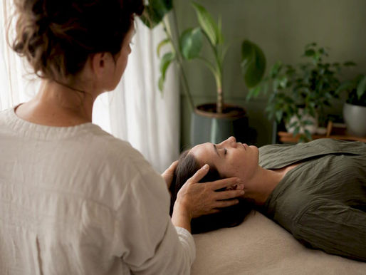 Therapist gently touching patient's head