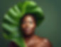 Dark skin lady with green leaf around her head 