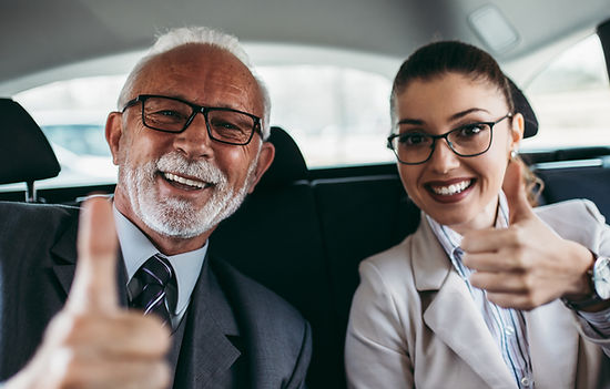 car passengers giving thumbs up to their ride experience