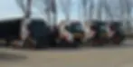 4 (quatre) véhicules floqués trak trans sont alignés légèrement en biais, mettant bien en avant le flocage des camions. Un camion à benne à ferraille, un camion grue, et deux porte-engins sont présents sur l'image.