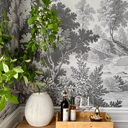 Black and white nature-themed wallpaper with a bar corner..