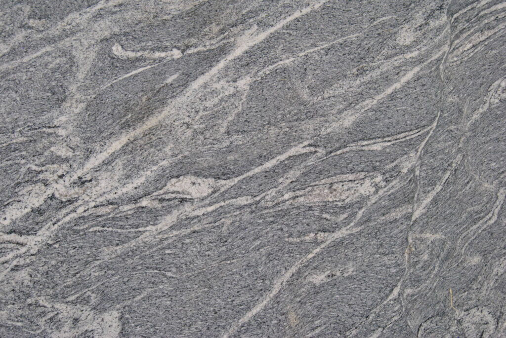 Close-up of gray Shadow Storm Marble with white veining background detail.