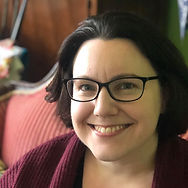 A photo of Laura Hale. They are a white person with short dark hair and black rimmed glasses.