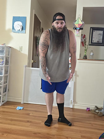 Picture of James Bigney wearing one ankle sock and one knee high sock