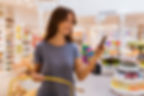 Woman Holding Phone While Shopping