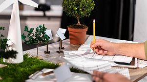side-view-of-man-working-on-an-eco-friendly-wind-power-project-with-paper-plans.jpg
