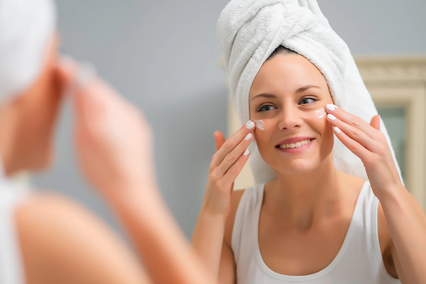 A person lathering foaming cleanser onto their face to cleanse away dirt, oil, and remaining impurities from the skin