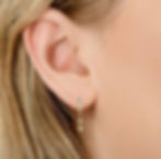 Huggies earrings that have hanging shooting stars made with gold vermeil and moissanites