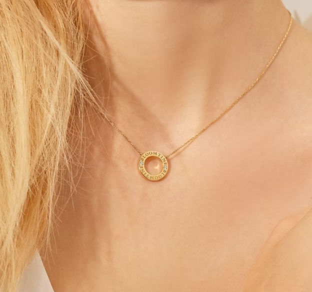 A blonde woman wearing a Mini Halo Wings™ Angel Necklace in Gold Vermeil with Diamonds