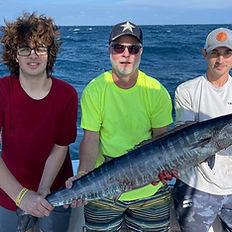 Just Right Florida Charters customers holding a wahoo for a picture
