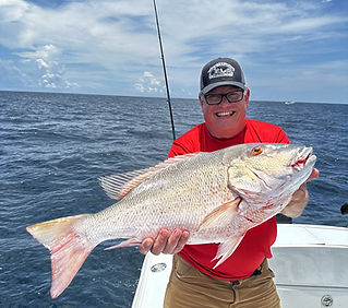 man holding a huge mutton snapper