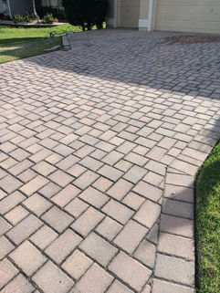 Pressure washing house driveway before