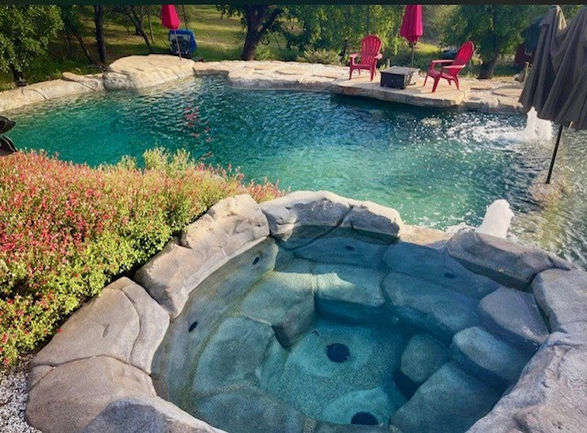 Custom spa overlooking swimming pool in Granite Bay by Yuba River Swimming Holes and Pools