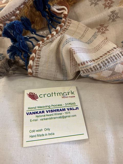 detail of a piece of fabric with the original commercial tag with manufacturing information still intact