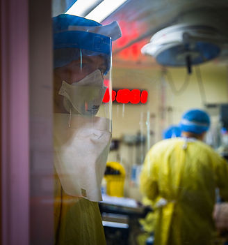 Doctor in Covid 19 face gear looking stressed