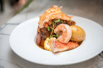 Seafood platter with lobster, shrimp, crab, corn, and potato