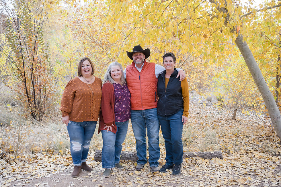 family with fall trees in the background