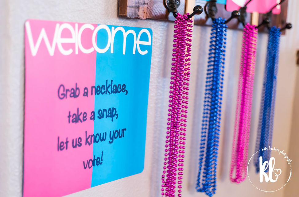 Gender Reval photo session with blue and pink mardi gras beads